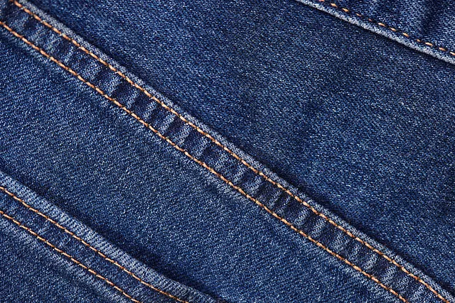 Detailaufnahme einer sauberen Doppelnaht auf blauem Jeansstoff.